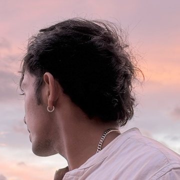 Aaron Marshall, photographed from behind against an evening sky